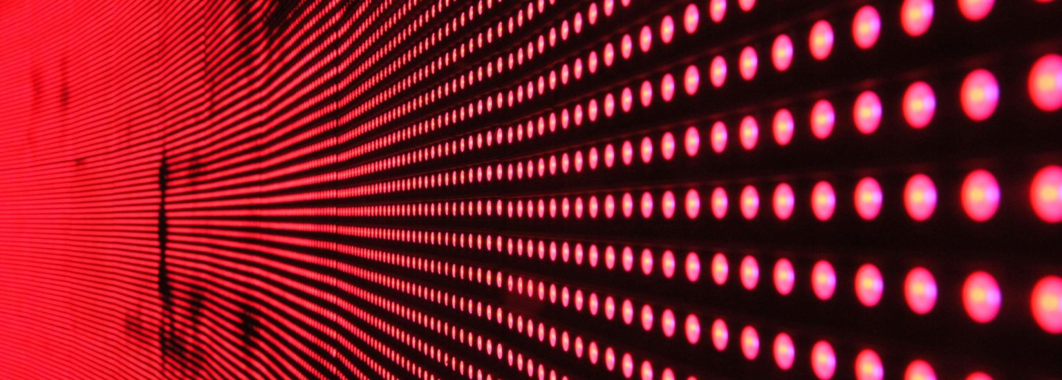 Vibrant abstract pattern of illuminated red LED lights forming a dynamic design.